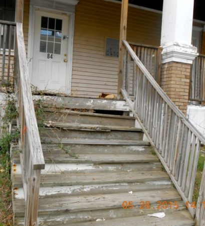 Photo of stairs with deteriorating paint.